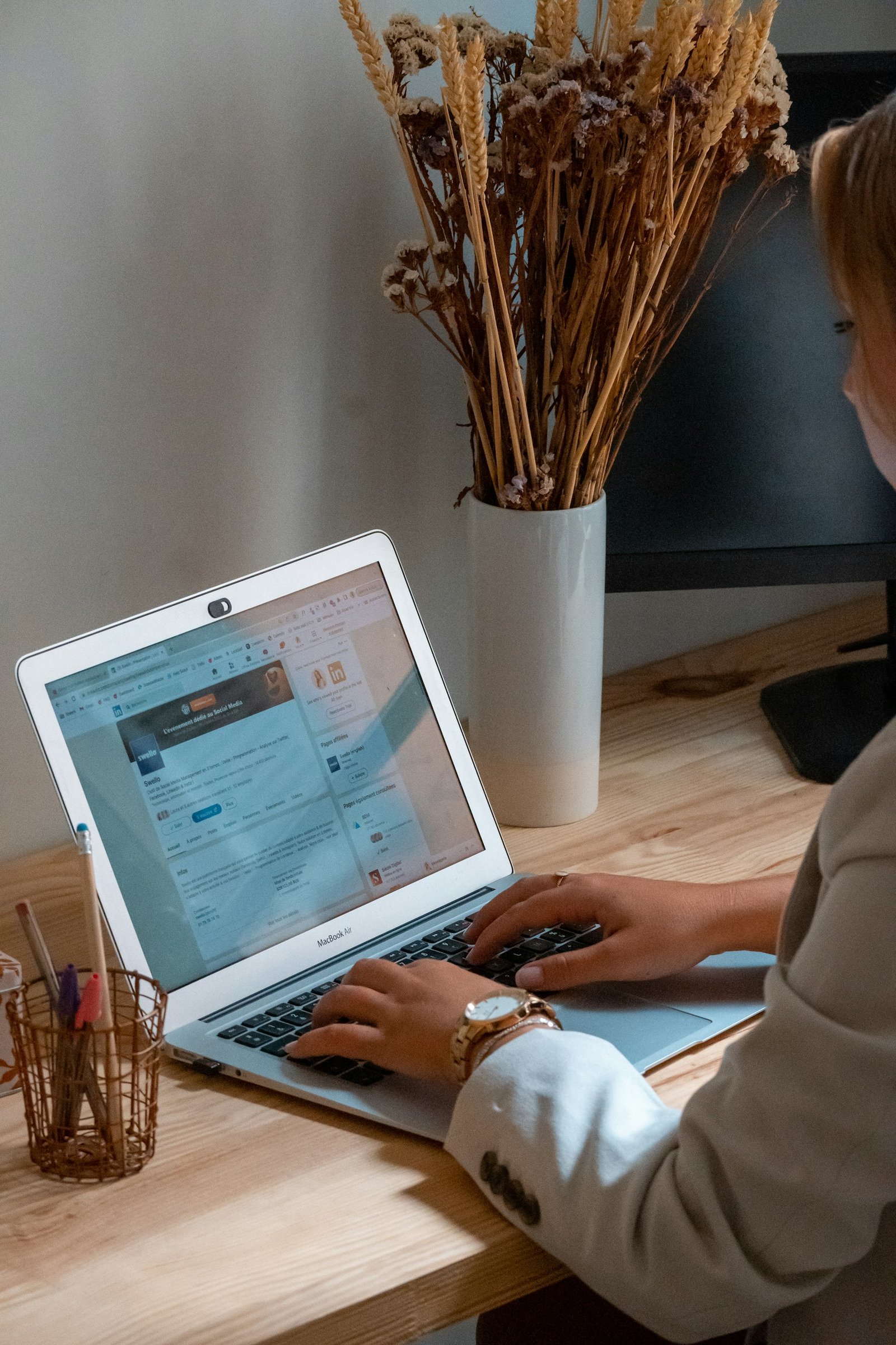 A person working at a laptop in a home office